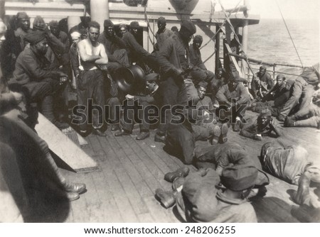 African American soldiers and white sailors on WW1 troop ship. July 18, 1919. The 803rd Pioneer Infantry Battalion on the deck of the U.S.S. Philippine from Brest harbor, France.