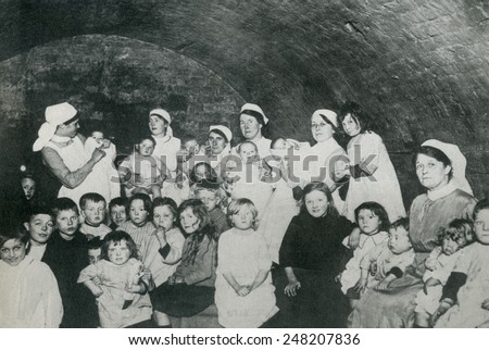 British nannies in a basement bomb shelter, probably in London during World War 1. From 1915-1918, Britain suffered approximately 50 raids with about 550 deaths and 1350 injuries.