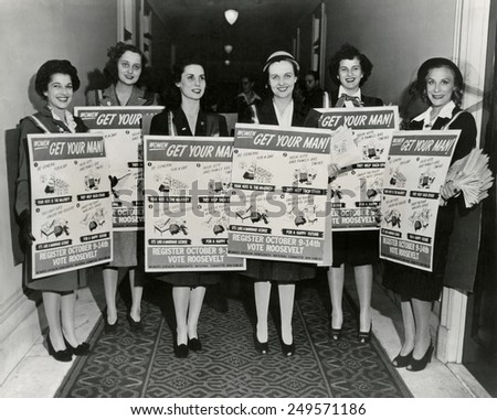 Democratic Women of New York wear signs for the 1944 national campaign registration. The humorous signs urge women to register and vote for Franklin Roosevelt.