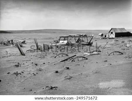 Buried machinery in a barn lot in Dallas, South Dakota in 1936. The Dust Bowl ecological disaster extended from Texas into the Northern Plains and Canada.