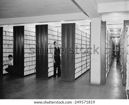 Federal workers in the patent office file room, where patents are kept on file for public use. Feb. 29, 1940.