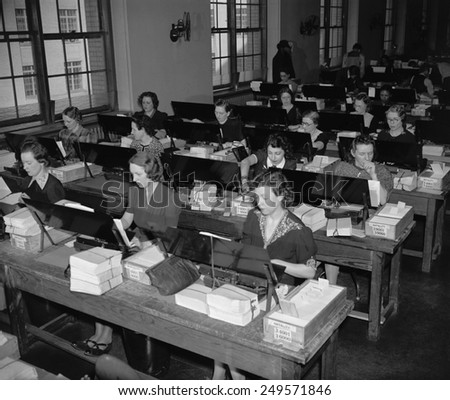 U.S. Census workers transferring birth records to a computer punch cards, ca. 1940.