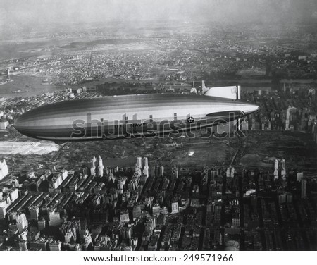 USS Akron in flight over New York City, ca. 1932. Akron, a helium-filled rigid airship of the U.S. Navy, crashed in a thunderstorm, killing all but two of her 74 crew on April 4, 1933.