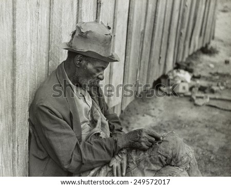 African American man with missing fingers wearing tattered clothing. Camden, Alabama, May 1939. Photo by Marion Wolcott.