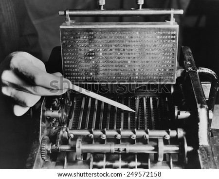 U.S. Bureau of the Census computer operator pointing out the interior mechanism of the punched card sorter, ca. 1940.