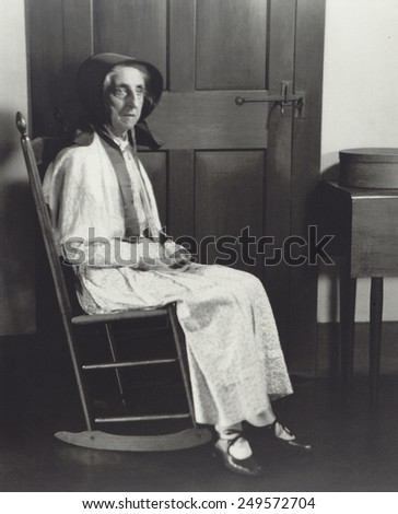 Sister Mathilde \'Tillie\' Schnell, in rocking chair at Hancock Shaker Village near Pittsfield, Massachusetts. 1935 photo by Samuel Kravitt was commissioned by Shaker historian Edward Deming Andrews.