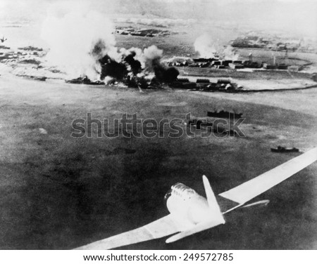 Photograph taken by a Japanese pilot, of the destruction of Pearl Harbor. At lower right is a Japanese bomber. Dec. 7, 1941.