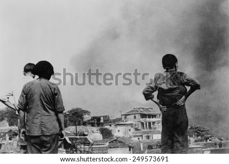 Three Chinese civilians in Chungking witness a Japanese air-raid. Second Sino-Japanese War/ World War 2. Ca.1937-45.