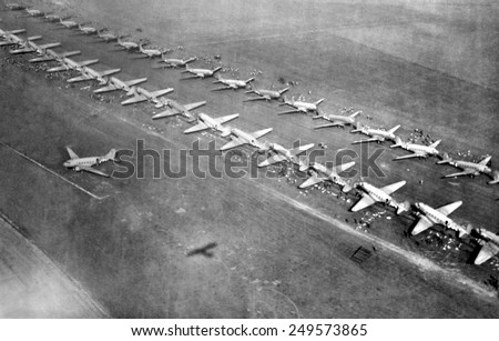Long lines of C-47 transports loaded with paratroopers at an English airfield, Sept. 17, 1944. Operation Market Garden would drop 34,600 airborne troops near key bridges in the Netherlands.