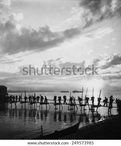 Silhouette of American troops at Pandu Ghat, India, enroute to Myitkyina, Burma. World War 2, Oct. 25, 1944.
