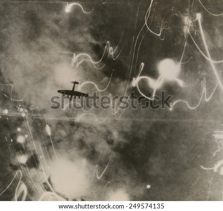 British RAF bomber and trails of light from incendiary bombs. Photo taken of the bombing of the shipbuilding yards in Hamburg during World War 2. Jan. 12, 1943.