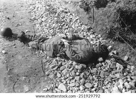 Dead U.S. soldier shot thru the head with his hands tied behind his back. He was one of four captured and executed by North Koreans on the night of July 9, 1950. Korean War, 1950-53.