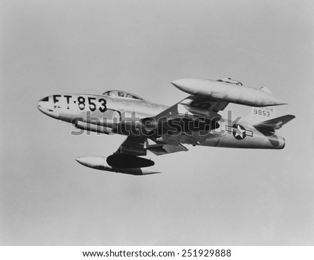 U.S. F-80 jet fighter carrying napalm in seventy five gallons dark colored wing tanks. Korean War, 1950-53.