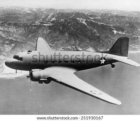 Douglas C-47 Skytrain in flight. The transport was used in in World War 2 and the Korean War. It was also developed as the civilian Douglas DC-3 airliner. Ca. 1942-45.