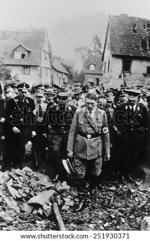 Adolf Hitler, with German military and officials, inspects bomb damage in a German city in 1944. World War 2.