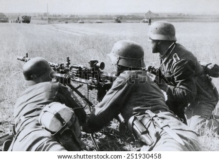 German soldiers fire a machine gun during the Nazi invasion of the Soviet Union (Russia). Summer 1941, during World War 2.