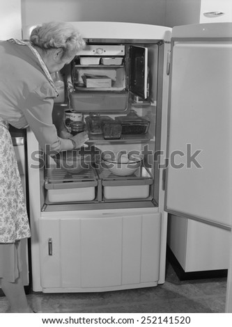 Interior of a 1940\'s refrigerator has a small freezer section. The most perishable foods were stored near the freezer. The bottom compartment contained the refrigeration unit. 1942.