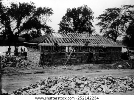 Great Depression, CCC (Civilian Conservation Core). Workers construct a sandstone and limestone house on the Maumee River, 1934.