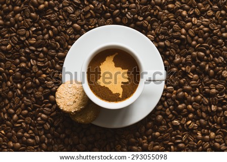 Still life photography of hot coffee beverage with map of Colombia
