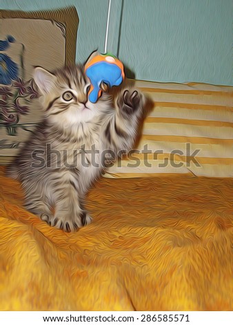 Little kitty playing with a toy fish on the bed