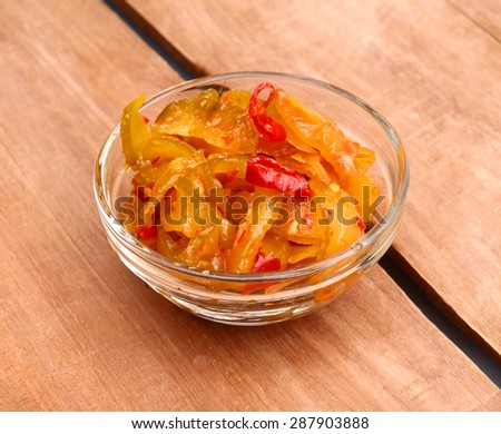Indian pickles on a white background in a glass bowl
