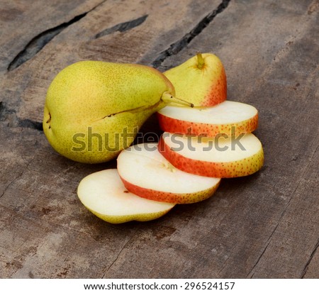 South African forelle pear fruit over white background on wooden board