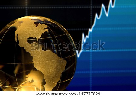 Glass globe over stock data on computer screen