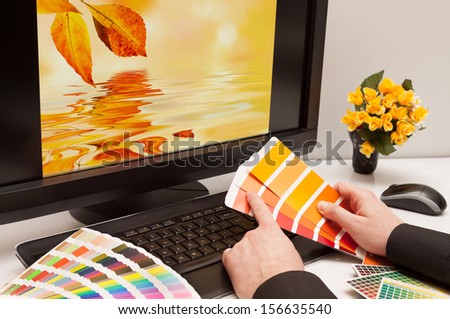 Graphic designer at work. Color samples. Brown, yellow images