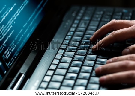 Hacker Using Laptop. Lots Of Digits On The Computer Screen.
