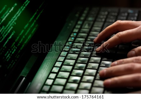 Hacker Using Laptop. Lots Of Digits On The Computer Screen.
