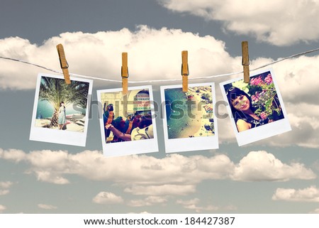 Photos of holiday hanging on clothesline by clothespins. Sky and cloud on background.