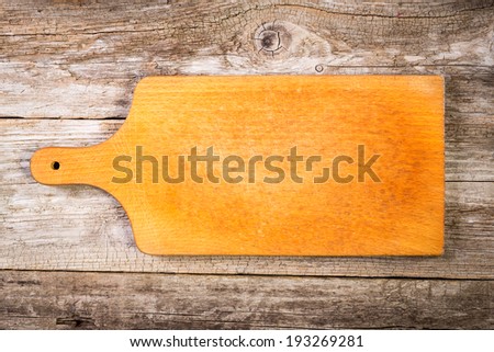 Empty vintage cutting board on planks food background.