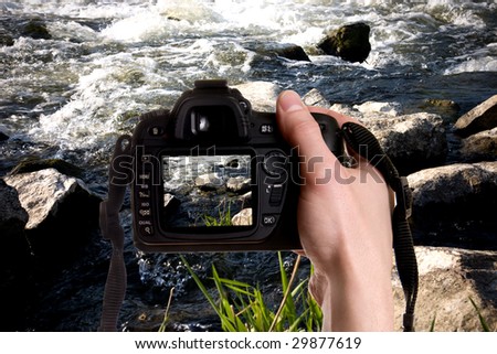 Man taking a landscape photography with a digital photo camera