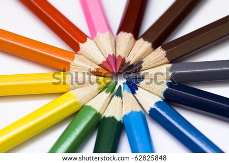 Close-up of a selection of colored pencil crayons, arranged like a color wheel.