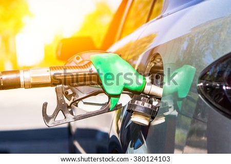 Gun petrol in the tank to fill. Car refueling concept.