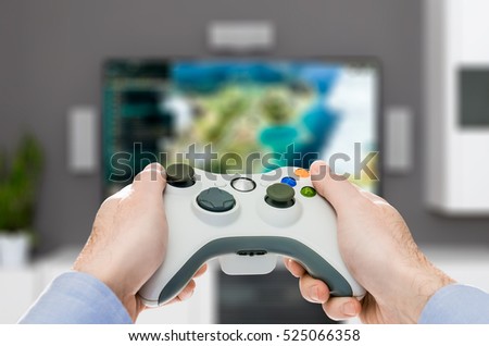 gaming game play tv fun gamer gamepad guy controller video console desktop playing player holding hobby playful enjoyment view concept - stock image