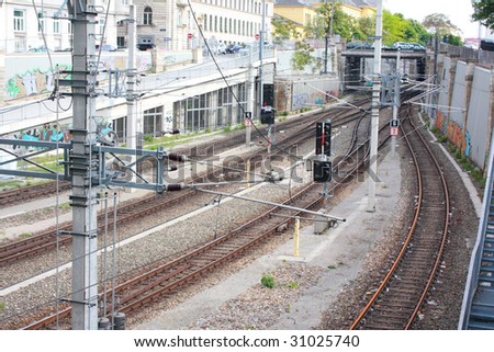 Railway tracks with electric wires and traffic lights