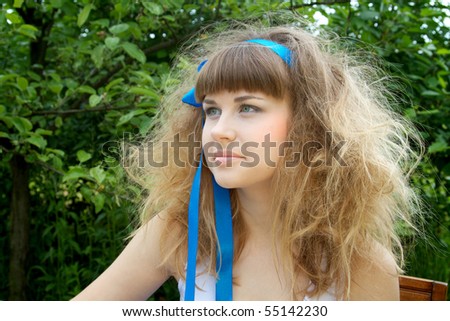 Beautiful girl with the crazy hair in the garden
