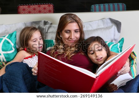 Mother telling stories daughters before bedtime