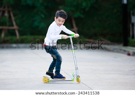 little asian boy play scooter