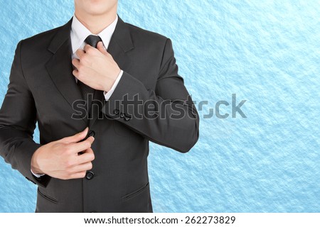 Well dressed businessman looklike smart adjusting  his neck tie on sky background : fill text