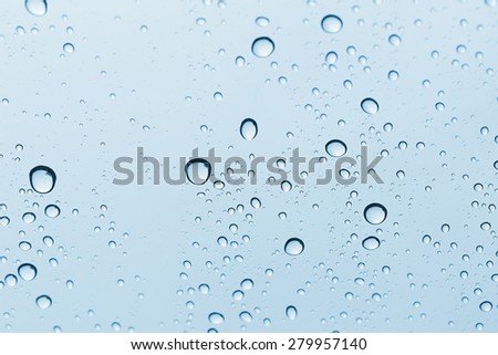 Blue Water drop on glass mirror background.