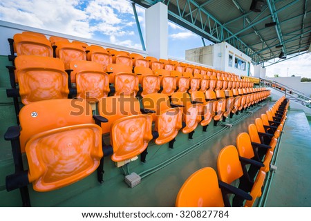 Orange empty seat of indoor stadium.