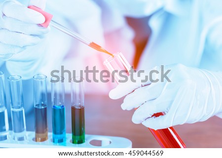 Female medical or scientific researcher using test tube on laboratory.