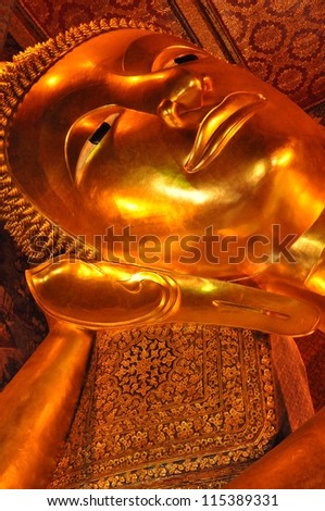 BANGKOK, THAILAND - AUGUST 12: Details of the Reclining Buddha statue at the Wat Pho temple in Bangkok, Thailand on August 12, 2012. The statue is 15m high and 43m long.