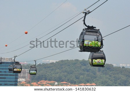 SINGAPORE - AUGUST 15: Cable cars from Singapore to Sentosa Island and back as seen on August 15, 2012. Sentosa has a theme park, sand beach, resort, yacht marina, hotel and luxury residence.