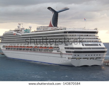 COZUMEL, MEXICO - NOVEMBER 23: The Carnival Conquest sails away from Cozumel in Mexico on November 23, 2012. The Godmother of Carnival Conquest is Lindy Boggs, former US Congresswoman for Louisiana.