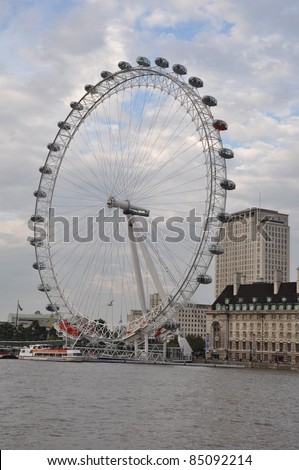 LONDON - SEP 1: The London Eye on the Thames River on Sep 1, 2011 in London. The London Eye is the most popular attraction of the UK and the tallest Ferris Wheel in Europe at 135 meters (443 feet).