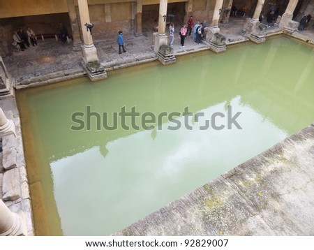 CITY OF BATH, ENGLAND - SEPTEMBER 7: Tourists at the ancient Roman Bath Museum in West England on Sept 7, 2011. The Baths are a major tourist attraction & receive more than 1 million visitors a year.