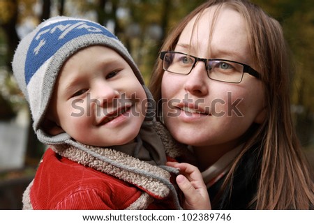 Portrait of happy child and mother. Autumn.